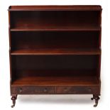 A REGENCY STYLE MAHOGANY WATERFALL BOOKCASE with shelves over two drawers manufactured by Redman &