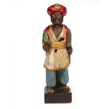 AN ANTIQUE CARVED WOODEN PAINTED TOBACCO ADVERTISING FIGURE wearing a turban and holding a knife