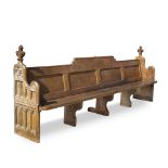 A PAIR OF 19TH CENTURY OAK PEWS with Gothic tracery decorated ends, surmounted by fleur de lis