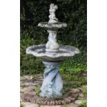 A CAST RECONSTITUTED STONE TWO TIER FOUNTAIN with scrolling decorations to the fountain bowls,