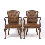 A PAIR OF GEORGE II STYLE WALNUT BROWN LEATHER UPHOLSTERED OPEN ARMCHAIRS with shaped buttoned