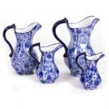 A GRADUATED SET OF FOUR BLUE AND WHITE POTTERY JUGS the largest 23cm wide x 27cm high Condition: