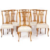 A SET OF TWELVE CONTINENTAL BEECHWOOD DINING CHAIRS with pierced splats, overstuffed upholstered