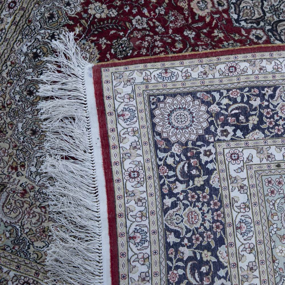 AN ORIENTAL SILK RED GROUND RUG with circular decoration to the floral field within a multiple - Image 2 of 2