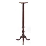 A 19TH CENTURY MAHOGANY TORCHIERE with a fluted stem and a triform base, 30cm diameter at the top