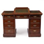 AN EDWARDIAN MAHOGANY PEDESTAL DESK with a leather inset sloping top, nine drawers, on plinth bases,