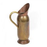 A VICTORIAN PRESSED COPPER AND BRASS STICK STAND in the form of a jug with a looping handle, 43cm