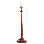 A 19TH CENTURY TURNED WALNUT CANDLESTICK with brass top Condition: slightly misshaped, surface marks