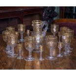 A SUITE OF MID 19TH CENTURY GILDED CUT GLASSWARE to include eleven wine glasses 8.5cm diameter x