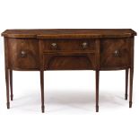 A GEORGE III STYLE MAHOGANY BREAKFRONT SIDEBOARD with two central drawers flanked by cupboard doors,