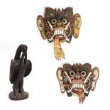 A PAIR OF MID 20TH CENTURY PAINTED INDONESIAN DRAGON FACE MASKS each 25cm wide x 22cm high and a