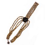 A TIGERS EYE BEAD NECKLACE with a rose pendant, 4cm diameter Condition: in good condition