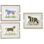 THREE HERMES PORCELAIN ASHTRAYS each decorated with horses, 19.5cm x 16cm Condition: the blue glazed