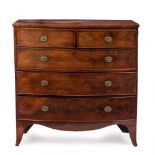 AN EARLY VICTORIAN MAHOGANY BOW FRONT CHEST OF TWO SHORT AND THREE LONG DRAWERS with brass oval ring