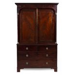 A 19TH CENTURY MAHOGANY LINEN CUPBOARD with twin panelled doors, pilaster column supports above
