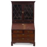 A GEORGE III MAHOGANY BUREAU with an associated Georgian mahogany glazed bookcase top, the top