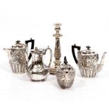 FOUR 19TH CENTURY SILVER PLATED TEAPOTS and a Victorian silver candlestick, the candlestick 32.5cm