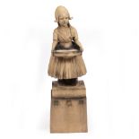 AN EARLY 20TH CENTURY ROYAL DOULTON STONEWARE FIGURE of a Dutch girl mounted on a pedestal with