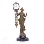 EARLY 20TH CENTURY SPELTER FIGURAL MYSTERY CLOCK with circular Arabic dial above pendulum 35cm in