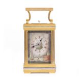 A LATE 19TH / EARLY 20TH CENTURY FRENCH BRASS CARRIAGE CLOCK the sides and dial with engraved