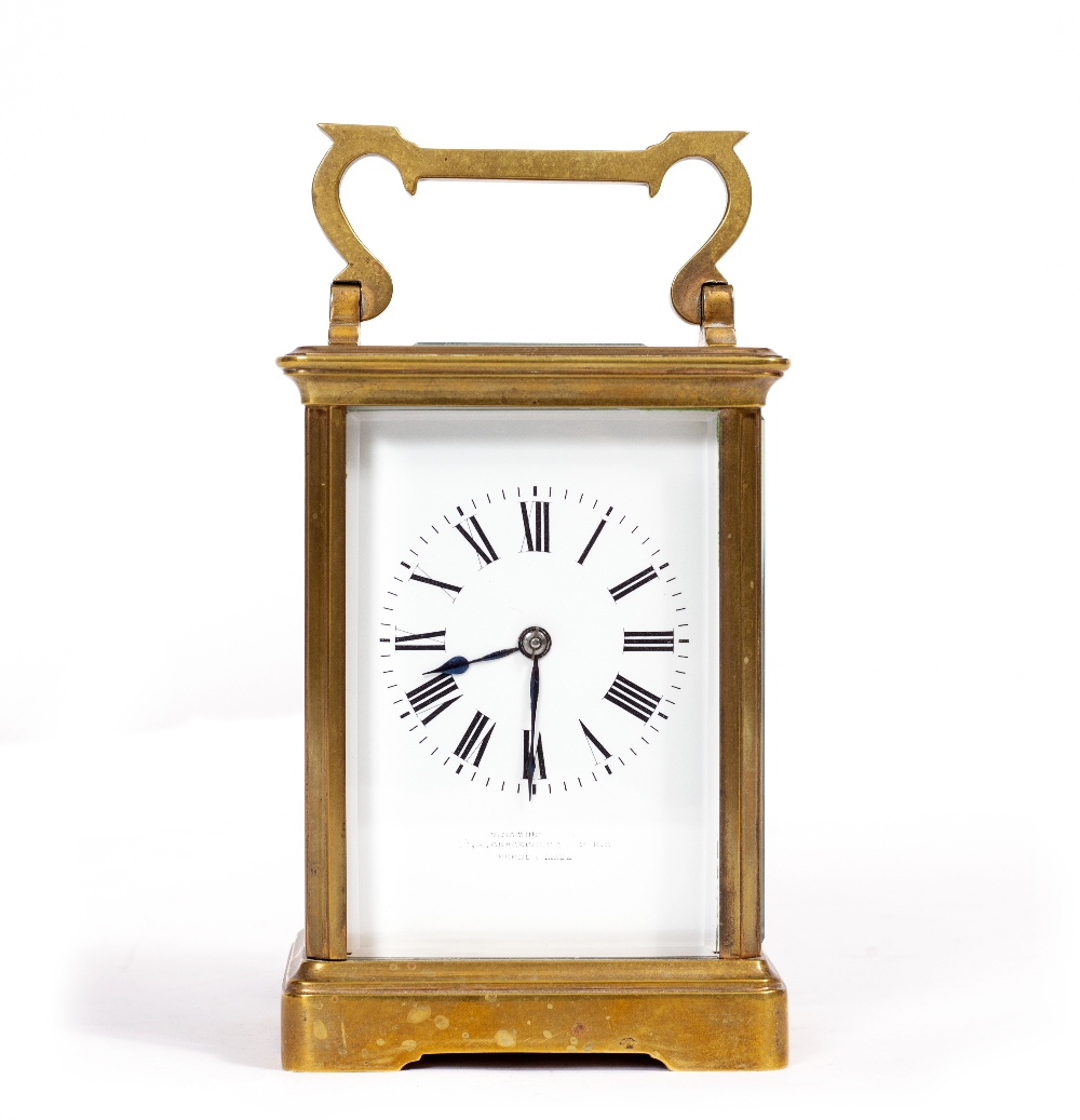 A BRASS CARRIAGE CLOCK, with enamel dial, striking the hours and half hours in a gong, 17cm high