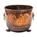 A 19TH CENTURY RIVETED COPPER COPPER with lions mask ring handles and three paw feet, 51cm