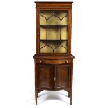 AN EDWARDIAN MAHOGANY BOW FRONTED DISPLAY CABINET with a single astragal glazed door above a