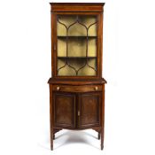 AN EDWARDIAN MAHOGANY BOW FRONTED DISPLAY CABINET with a single astragal glazed door above a