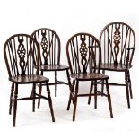 A SET OF FOUR 20TH CENTURY WHEEL BACK KITCHEN CHAIRS with turned supports to include one carver, the