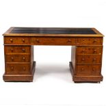 A VICTORIAN OAK PEDESTAL DESK with nine drawers, turned knob handles and raised on plinth bases,