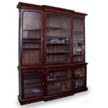A VICTORIAN MAHOGANY BREAKFRONT BOOKCASE with six glazed doors, opening to reveal adjustable