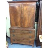 A 19TH CENTURY MAHOGANY LINEN PRESS with twin panelled doors opening to reveal converted hanging
