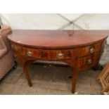 A GEORGE III MAHOGANY DEMI LUNE SIDE TABLE with a central drawer flanked by two deep drawers and