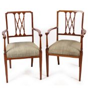 A PAIR OF 19TH CENTURY SATINWOOD OPEN ARMCHAIRS with upholstered seats and square tapering legs,