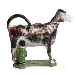 A LATE 18TH CENTURY PRATT WARE COW CREAMER with sponged decoration, 17cm wide x 13.5cm high