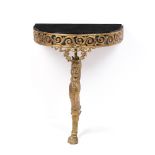 A SMALL GILT BRASS BOW FRONTED CONSOLE TABLE with inset black glass top and leopard monopodia