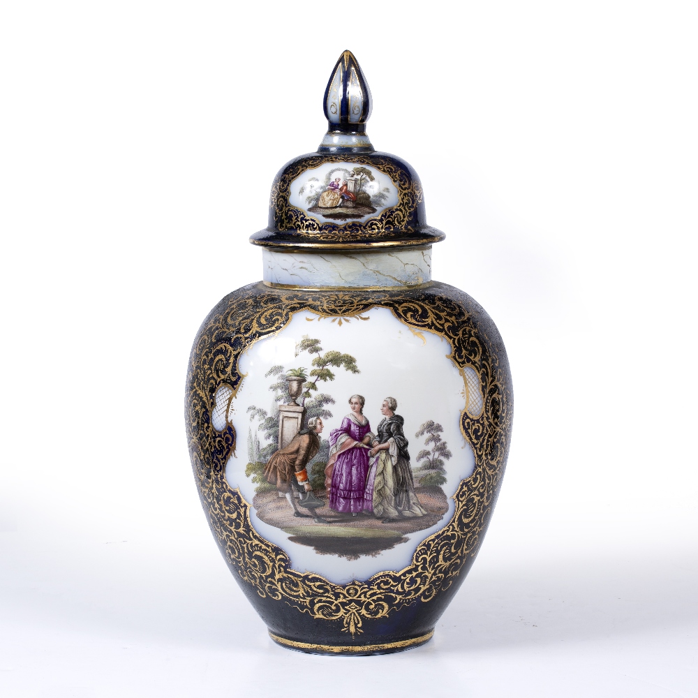 A DRESDEN PORCELAIN VASE AND COVER on a dark blue ground, the cartouches to either side, one painted
