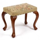 A 19TH CENTURY INDIAN TEAK STOOL with tapestry upholstered seat and four cabriole legs, 56cm wide
