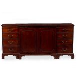 A REPRODUCTION GEORGIAN STYLE MAHOGANY BREAKFRONT SIDEBOARD with twin panelled doors flanked by