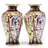 A PAIR OF NORITAKE PORCELAIN VASES of hexagonal baluster form, with polychrome decoration, each 16cm