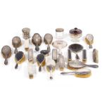 A LARGE QUANTITY OF SILVER DRESSING ITEMS to include silver brushes, silver pots, silver lidded