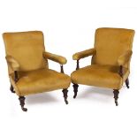 A PAIR OF VICTORIAN WALNUT FRAMED UPHOLSTERED EASY ARMCHAIRS by Gillows with turned and fluted