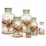 A 19TH CENTURY GRADUATED SET OF GLASS CONTAINERS of cylindrical form with floral sprays and gilded