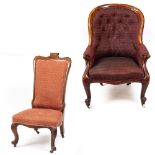 A VICTORIAN CARVED WALNUT FRAMED UPHOLSTERED ARMCHAIR with scrolling arms, cabriole legs and ceramic