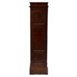 A VICTORIAN MAHOGANY NARROW FLOOR CUPBOARD with lifting top above a single door, on a plinth base,