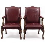 A PAIR OF RED LEATHER UPHOLSTERED OPEN ARMCHAIRS with cabriole legs and claw and ball feet, each