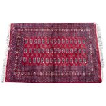 A MID TO LATE 20TH CENTURY EASTERN BOKHARA RED GROUND WOOLLEN RUG 181cm x 122cm Condition:
