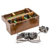 A WORLD WAR II STEREOSCOPES UNIVERSAL TYPE S.V2 in a fitted wooden case with key and further spares,