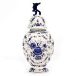A CONTINENTAL BLUE AND WHITE TIN GLAZED DELFT STYLE OCTAGONAL VASE AND COVER decorated with floral