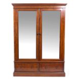 A VICTORIAN MAHOGANY WARDROBE with twin mirrored doors above two drawers with turned handles and a